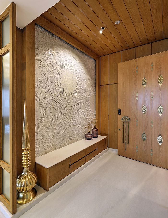 A bathroom with a large tub in the middle of the room and two sinks and two sinks on the wall next to a bathtub in front of a large window that has a wooden flooring is shown in